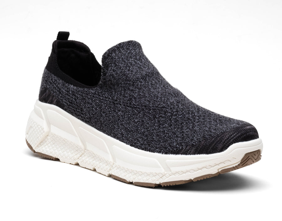black woolf sneackers shoe three-quarter angle breathable fabric, white sole, and back pull tab for easy wear